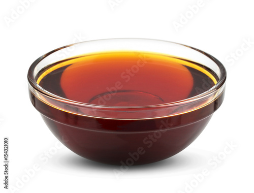Golden syrup isolated on white background, honey in bowl