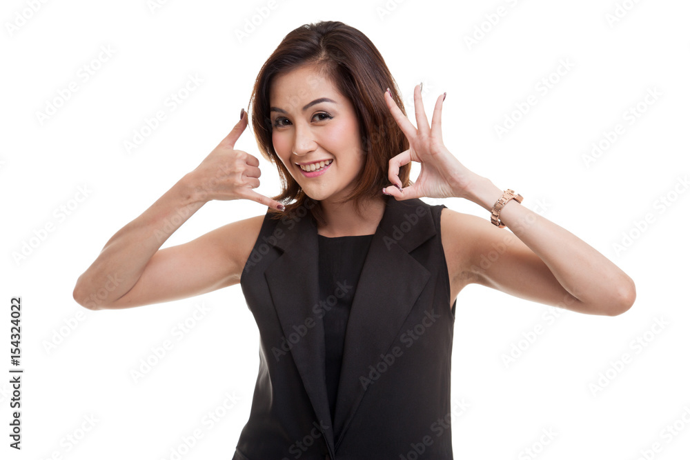 Young Asian woman show with phone gesture and OK sign. Young Asian woman show with phone gesture and OK sign.
