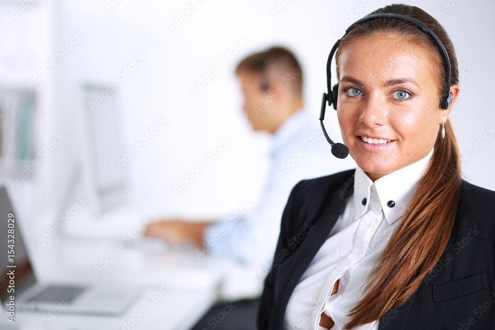 Happy female wearing headset and sitting on the desk Happy female wearing headset and sitting on the desk