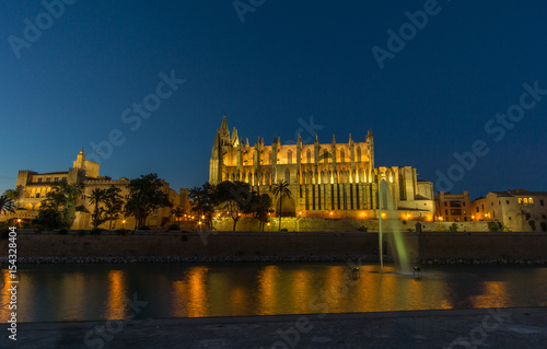 Palma de Mallorca Cathedral sunset. Night lighting reflected in water. Balearic islands of Spain