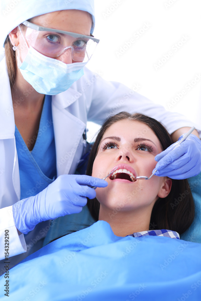 Woman dentist working at her patients teeth Woman dentist working at her patients teeth