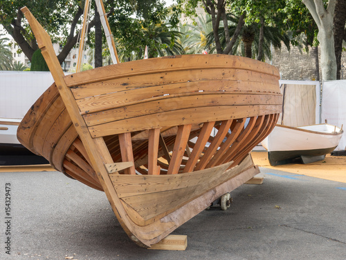 Boat hull, skeleton of a wooden boat, wooden structure composed by Keel and frames of a half-built boat photo