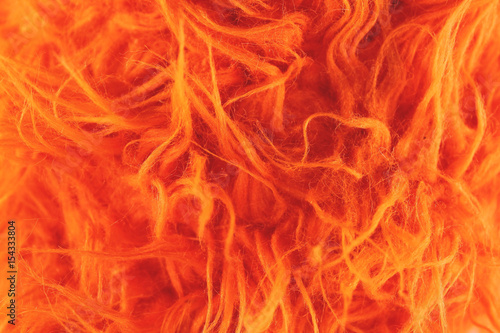 Yellow fur texture background. Synthetic orange fur is made to protect nature and protest against the killing of animals. Close-up of Artificial Wool photo