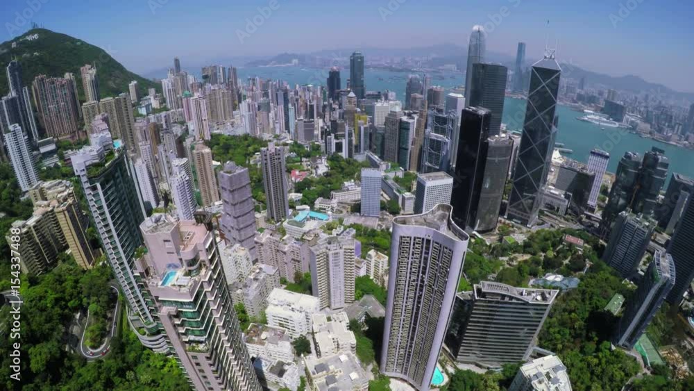 Hong Kong City Aerial. Beautiful Clear Blue Sky.
4K Aerial view capturing the general Hong Kong Island. Wide aerial forward shot flying over office buildings and skyscrapers.