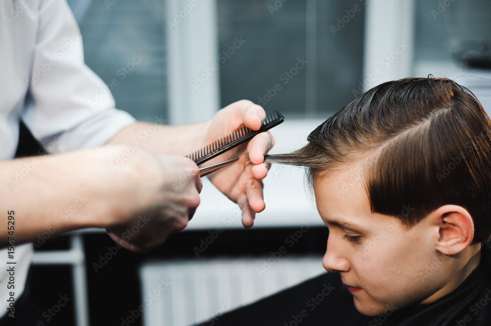 cute young boy getting a haircut