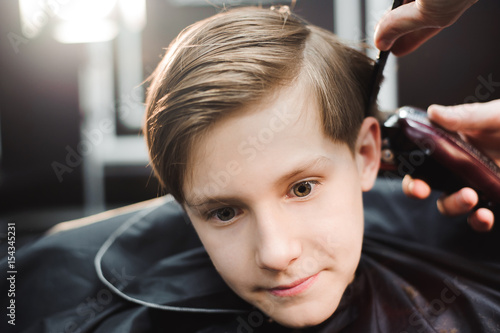 cute young boy getting a haircut