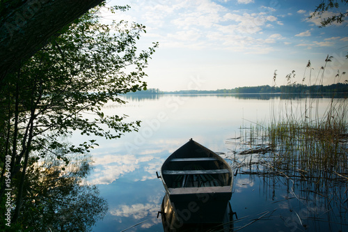 Fototapeta Naklejka Na Ścianę i Meble -  Rowing boat floating over the Lake Selment Wielki waters. Masuria, Poland.