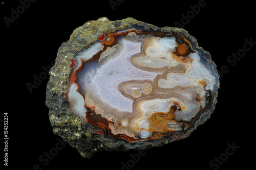 A cross section of the eyelet agate stone. Multicolored silica rings colored with metal oxides are visible. Origin: Asni, Atlas Mountains, Morocco. photo