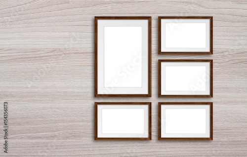 Five frames set on wooden panels wall, interior decor mock up.