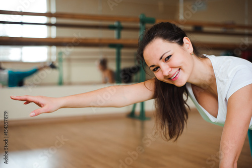 Fitness, sport, exercising lifestyle - Happy women wear in bodysuits doing exercises at gym