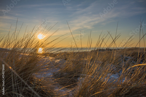 Beautiful Sunset In Sand Dunes Of Blavand Beach With Grass In Front / Denmark photo