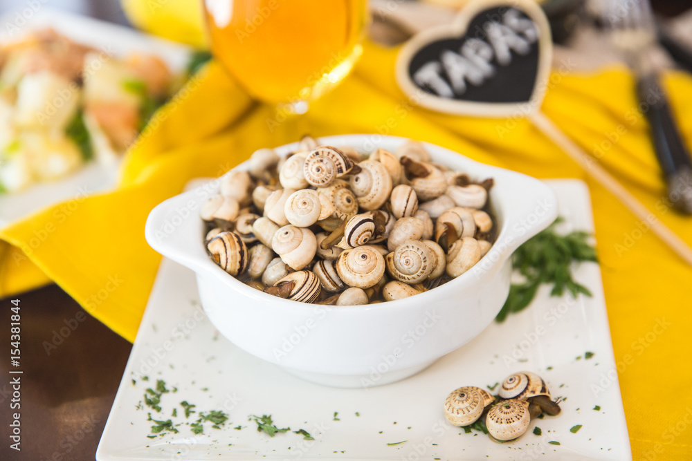 Tasty prepared snails on the table. Spanish cousine. Tapas Tasty prepared snails on the table. Spanish cousine. Tapas