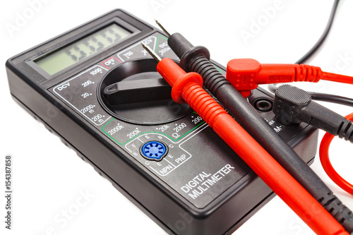 Digital multimeter with probes on a white background photo