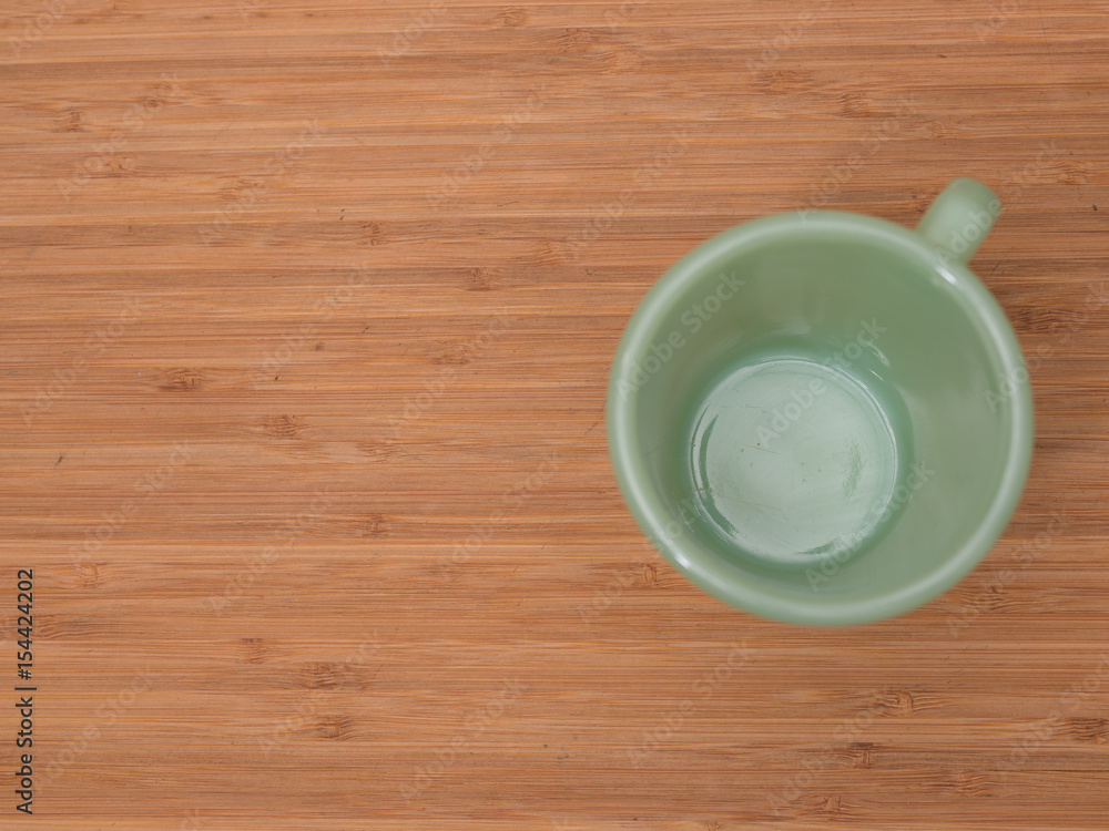 Empty green cup on cutting board Empty green cup on cutting board