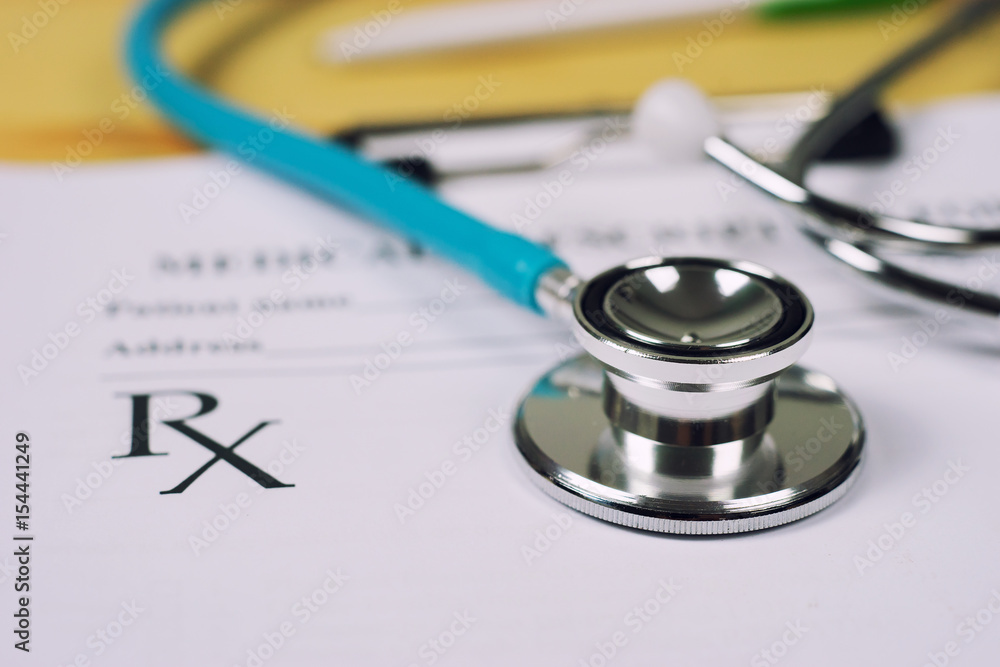 Stethoscope with prescription clipboard and Laptop ,Doctor working an Exam, Healthcare and medical concept,test results in background,vintage color,selective focus Stethoscope with prescription clipboard and Laptop ,Doctor working an Exam, Healthcare and medical concept,test results in background,vintage color,selective focus