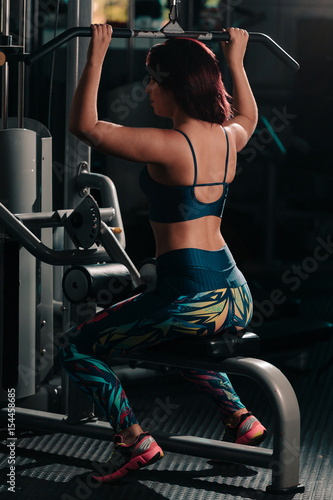 Young woman doing exercises at the gym. Concept of healthy life