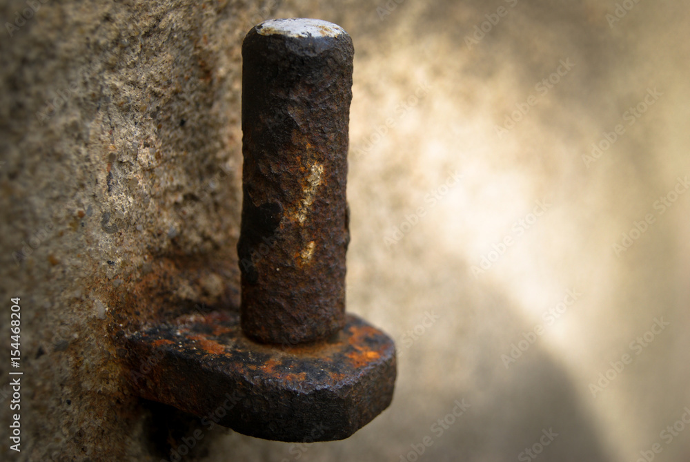 Closeup of old rusty door hinge on stone background Closeup of old rusty door hinge on stone background