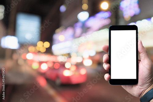 blank screen smartphone with blurred background taxi parking; intelligence application and internet concept. photo