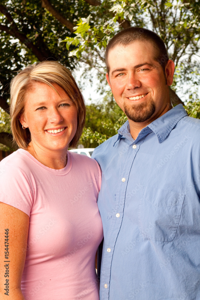 Happy couple smiling and hugging in the park. Happy couple smiling and hugging in the park.