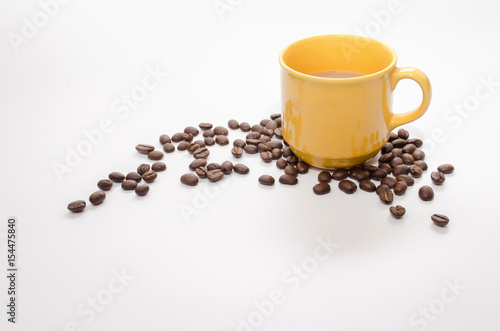 coffee beans and yellow coffee cup isolated on white background