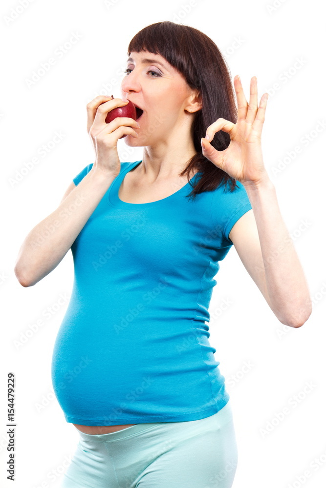 Happy pregnant woman eating fresh apple and showing sign ok, healthy food during pregnancy Happy pregnant woman eating fresh apple and showing sign ok, healthy food during pregnancy