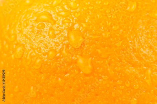 Close-up photo of juicy wet orange fruit