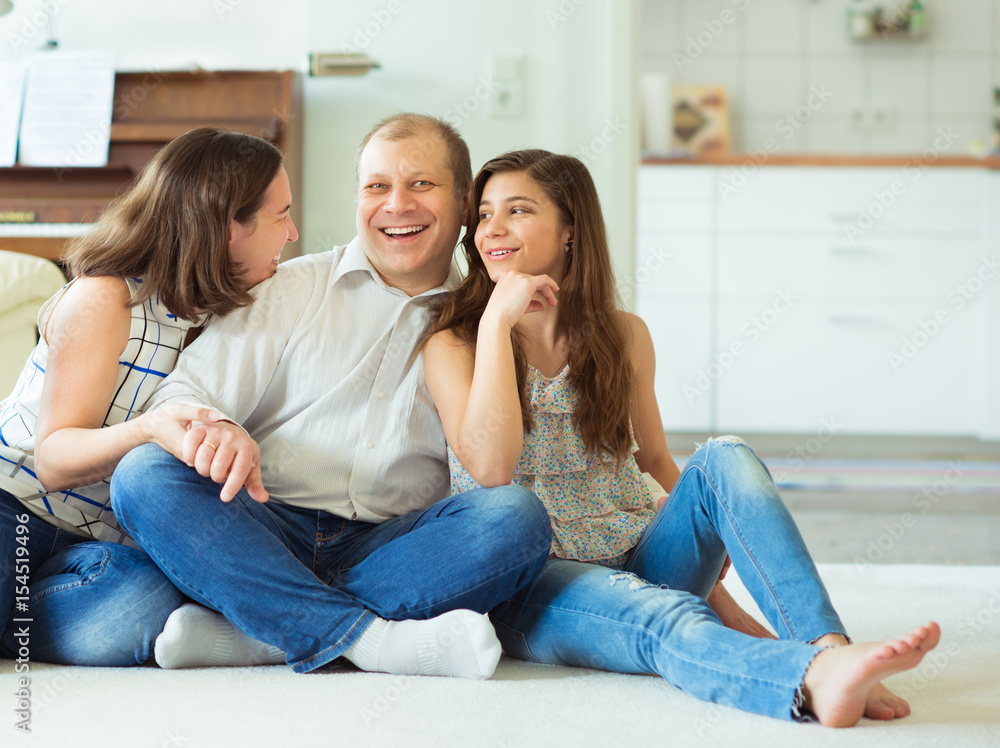 Portrait of young happy family with pretty teenager daughter having fun together at home Portrait of young happy family with pretty teenager daughter having fun together at home