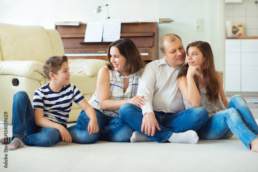 Portrait of young happy family with pretty teenager daughter and son having fun together Portrait of young happy family with pretty teenager daughter and son having fun together