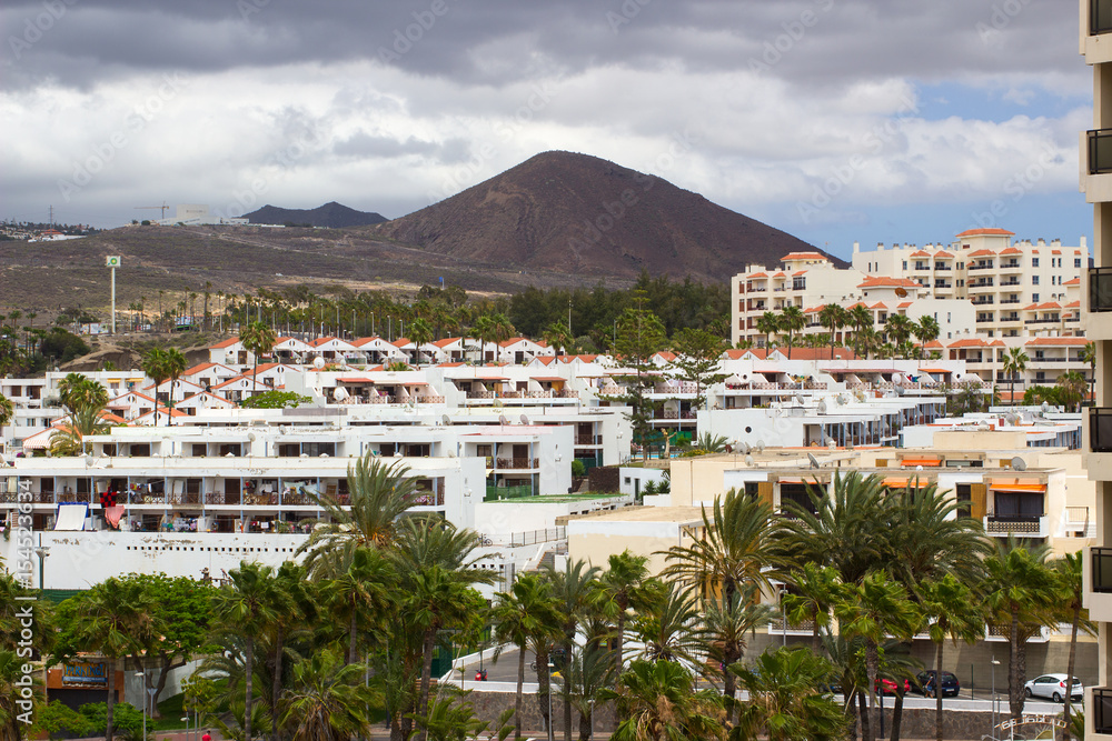 The bleak volcanic mountains and hills overlooking Playa Las Americas and Los Christianos in Teneriffe in the Canary Islands on a dull day