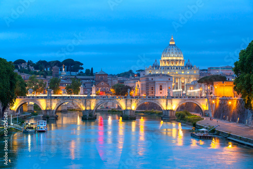 Evening view at the Angelo bridge and St. Peter's Basilica in Rome, Italy