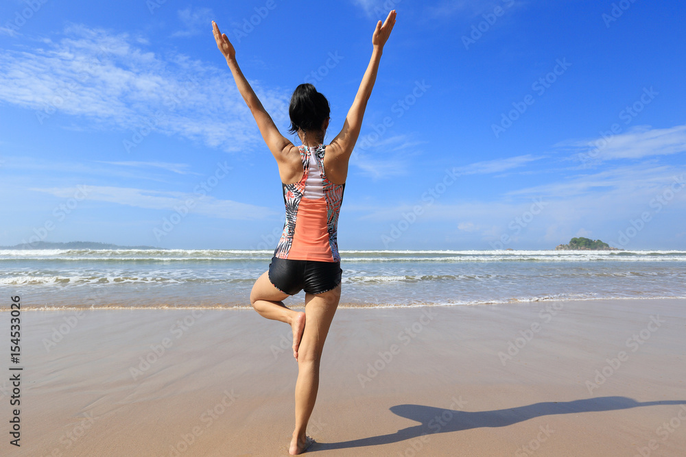 Young fitness woman wear swimsuit practice yoga on the beach Young fitness woman wear swimsuit practice yoga on the beach