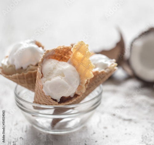 Vanilla-coconut ice cream in a waffle cone