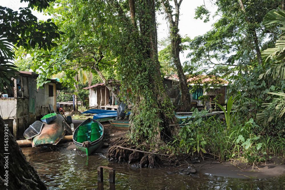 Obraz premium Boats on the banks of the Tortuguero river in Tortuguero, Costa Rica