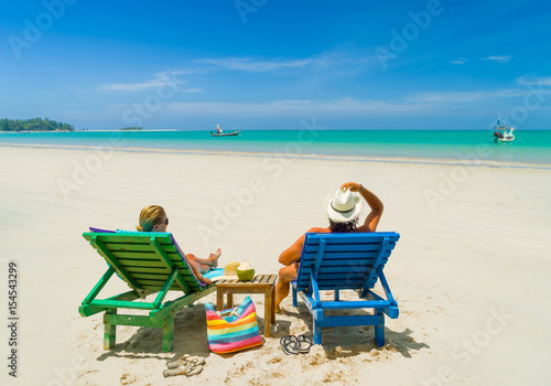Mature Couple Relaxing in Deck Chairs on Tropical Beach