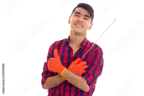 Young man in gloves holding tape-measure