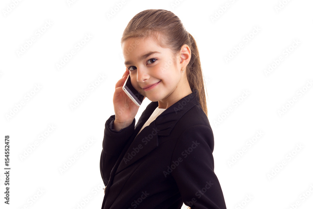 Little girl in black jacket talking on the phone Little girl in black jacket talking on the phone