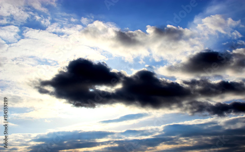 Fototapeta Naklejka Na Ścianę i Meble -   background of blue sky and sun under dark clouds