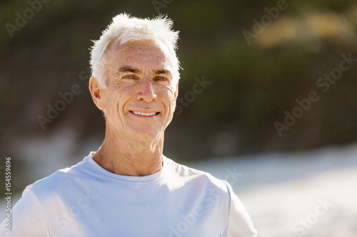 Man standing on beach in sports wear