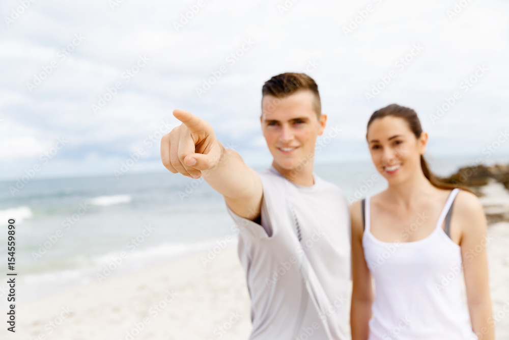 Couple of runners standing together on beach Couple of runners standing together on beach