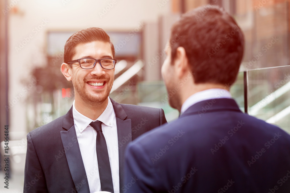 Two businessmen talking outdoors Two businessmen talking outdoors