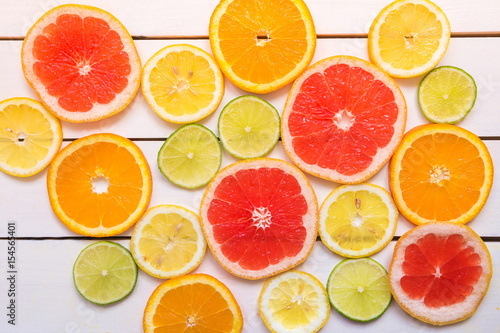 Grapefruit, orange, lemon, lime on the wooden white table. Top view