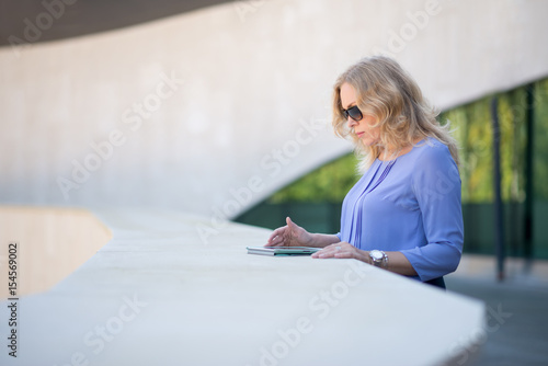 Beautiful business woman uses a digital tablet