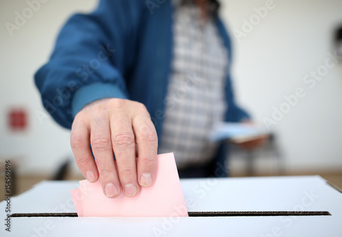 Man casts his ballot at elections photo