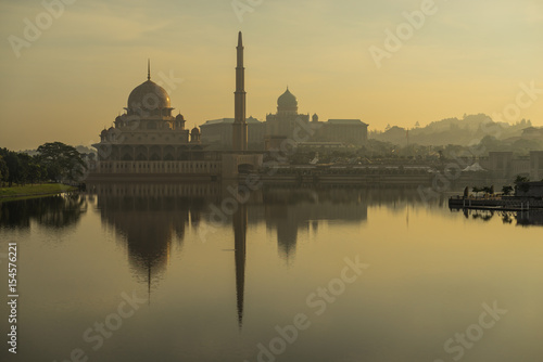 PUTRAJAYA, MALAYSIA - 16TH APRIL 2017; Sunrise moment at Putra Mosque, a principal mosque of Putrajaya, Malaysia. Construction of the mosque began in 1997 and was completed two years later.
