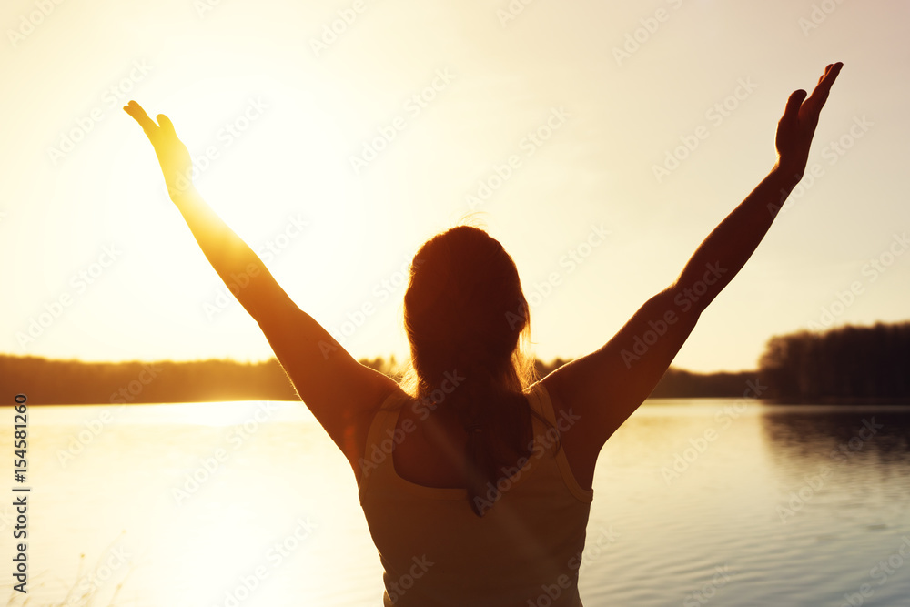 Fototapeta premium Happy woman enjoying sunset time near water