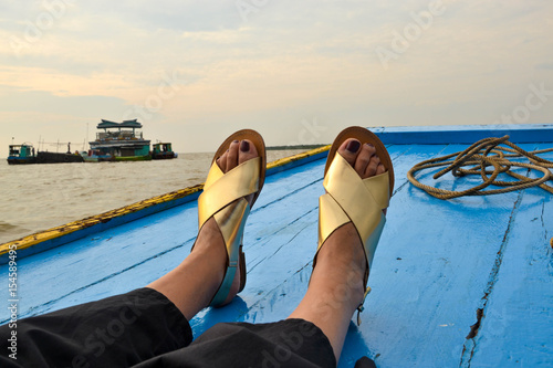 Golden shoe on boat sailing in a lake