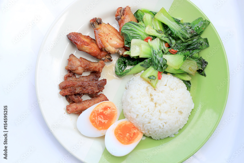 stir fried vegetables, Hard-boiled egg, Fried pork and Fried chicken wings with thai jasmine rice on dish. Thai food. stir fried vegetables, Hard-boiled egg, Fried pork and Fried chicken wings with thai jasmine rice on dish. Thai food.