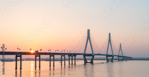 cable stayed bridge with setting sun © chungking
