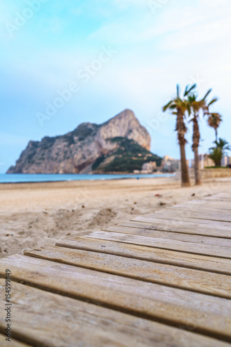 landscape of one of the beaches of Calpe  Alicante  Spain with Penon of Ifach and platform made of wood