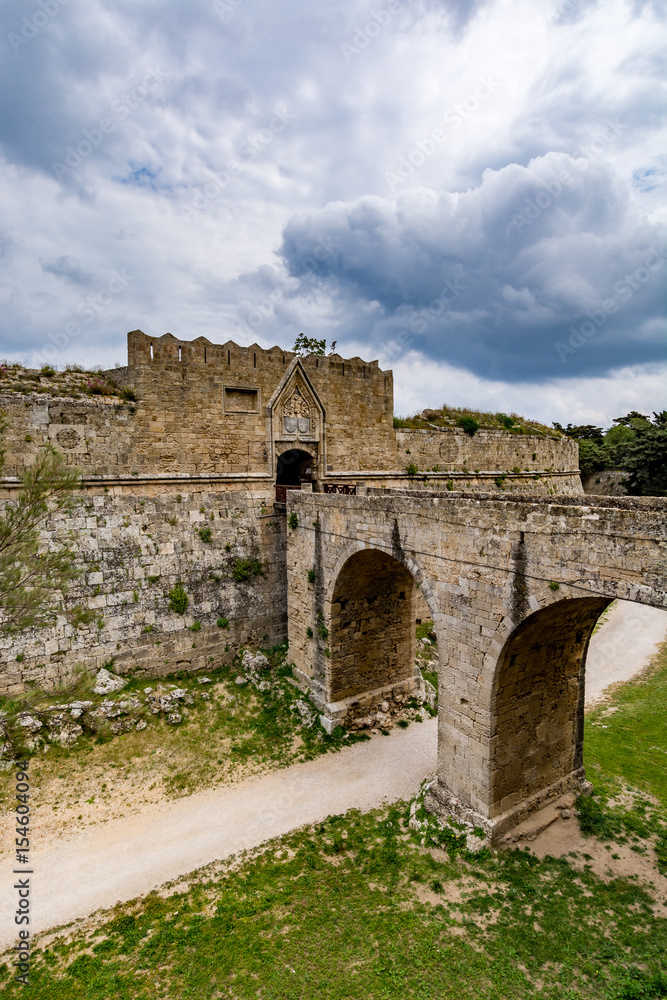 Gate of Saint John, bridge leading to it and moat at Rhodes old town, Greece 
